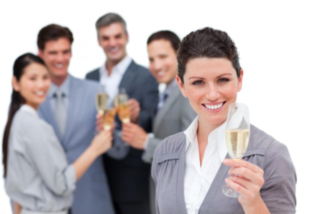 workers at holiday party toasting champagne