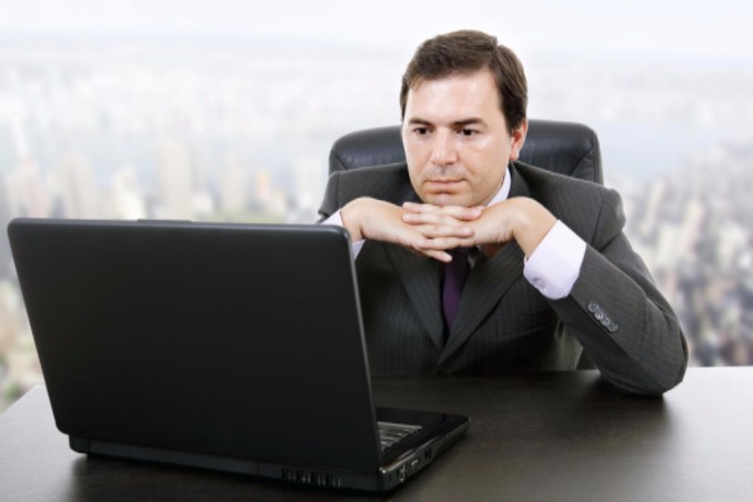 man scanning computer for social media