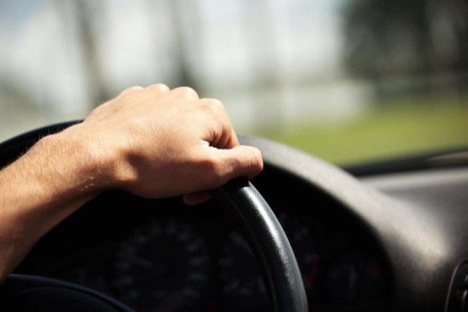 Close up of hand on steering wheel: WorkingManLaw Personal Injury Blog